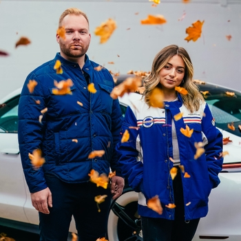 Two people wearing Porsche jackets
