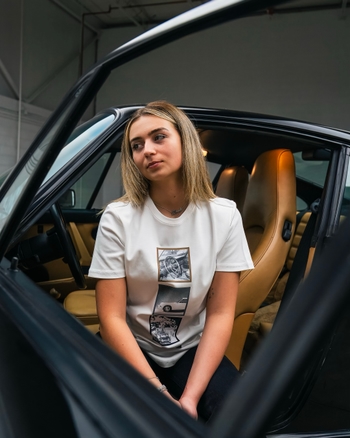 Girl sitting in a Porsche