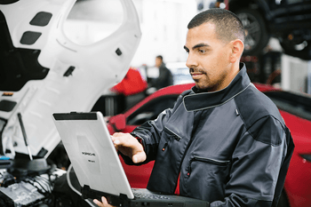 Porsche technician diagnosing