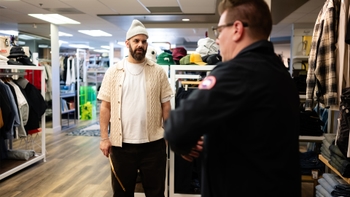 Asif Moola speaks with a customer at Momentum Clothing in Saskatoon