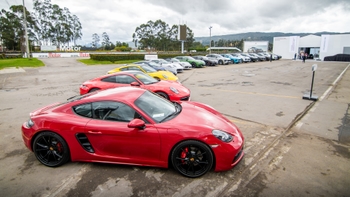 Porsche exclusive models parked one next to the other in a semi-circle shape