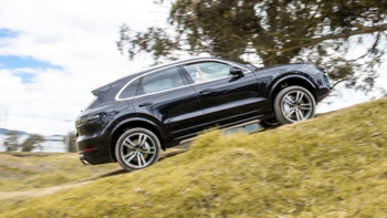 Porsche Cayenne black moving upwards on a slope