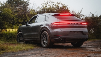 Porsche Cayenne parado en medio de una carretera despaimentada.
