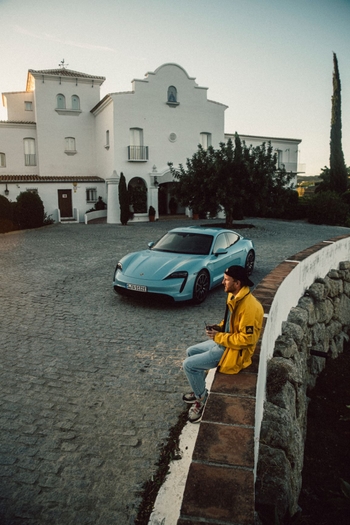 man with taycan in city