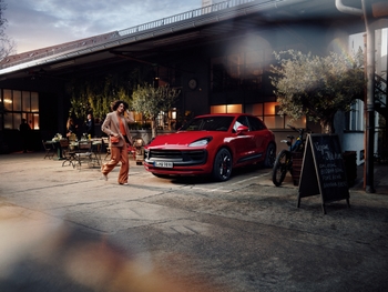 Red Porsche Macan GTS in an outdoor location.