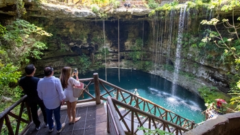 3 people enjoying of a waterfall at Selva Maya