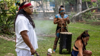 Three maya people practising a ritual to honor the land