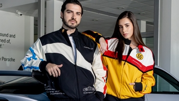 Modelos posando con 2 chalecos de Porsche, uno blanco y negro y otro amarillo blanco y rojo.