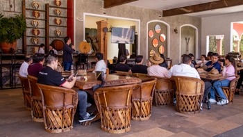 Porsche clients enjoying of refreshments while having a talk from a Porsche representative