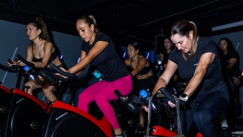 Women enjoying a spinning class hosted by Porsche