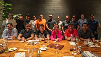 Porsche clients sitting over a table all together