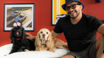 Two Cocker Spaniel dogs posing with its owner, a Porsche client