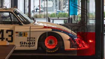 this is a white classic Porsche on display in glass