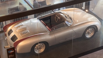 this is a white classic Porsche on display in glass
