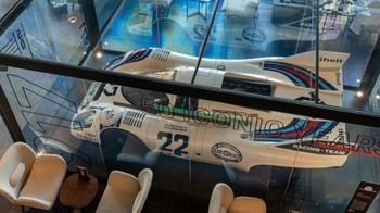this is a white classic Porsche on display in glass