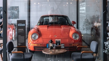 this is a lava orange classic sport Porsche on display