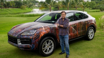 Eduardo Navarro al lado de un Porsche Cayenne Coupé que el mismo pintó