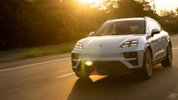 Porsche Macan Electric white and a sunset on the background