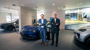 Porsche associates posing in front of the models inside the PC Lima