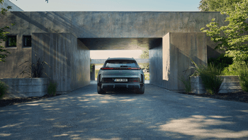 Porsche Cayenne in Mystic green parked under concrete gate